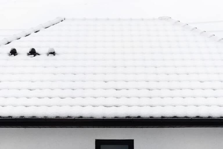 Tiled roof blanketed in heavy snow with three rounded vent caps barely visible above the snow line in Lancaster, PA